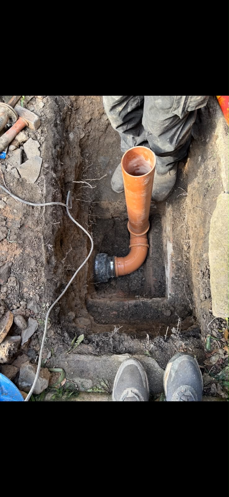 New drain pipe fitted inside inspection chamber