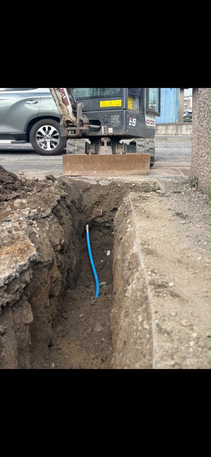 Mains water pipe installation with excavator